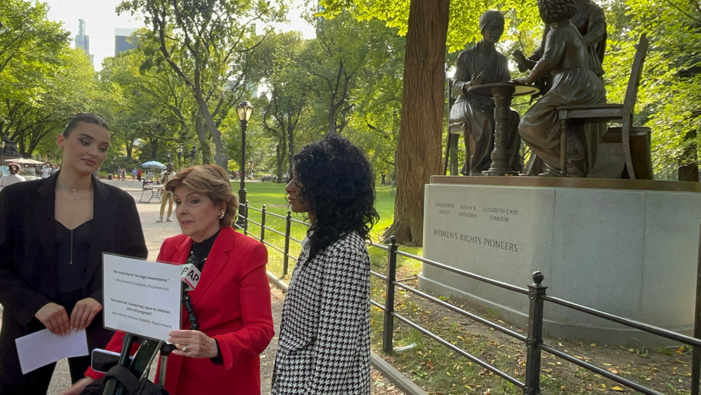 Veronika Didusenko, Gloria Allred, and Danielle Hazel in front of the Women's Rights Pioneers Monument in Central Park