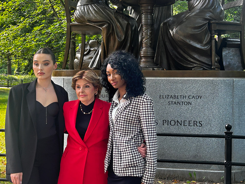 Veronika Didusenko, Gloria Allred, and Danielle Hazel in front of the Women's Rights Pioneers Monument in Central Park